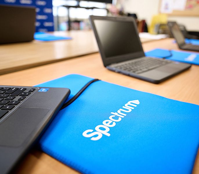 Laptops in a row in an empty computer lab