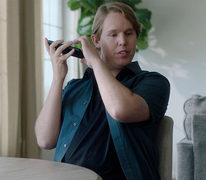 Vision impaired man using mobile device for audio