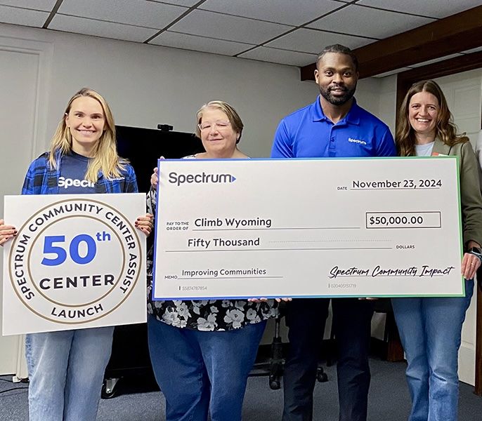 Spectrum Community Center Assist volunteers posing with a vanity check