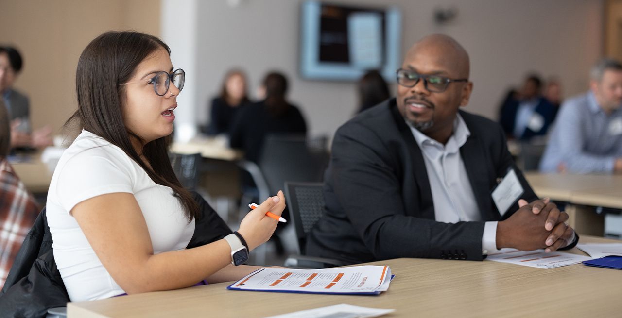 A Spectrum Scholar chats with her mentor and peers during the 2023 Scholars Summit