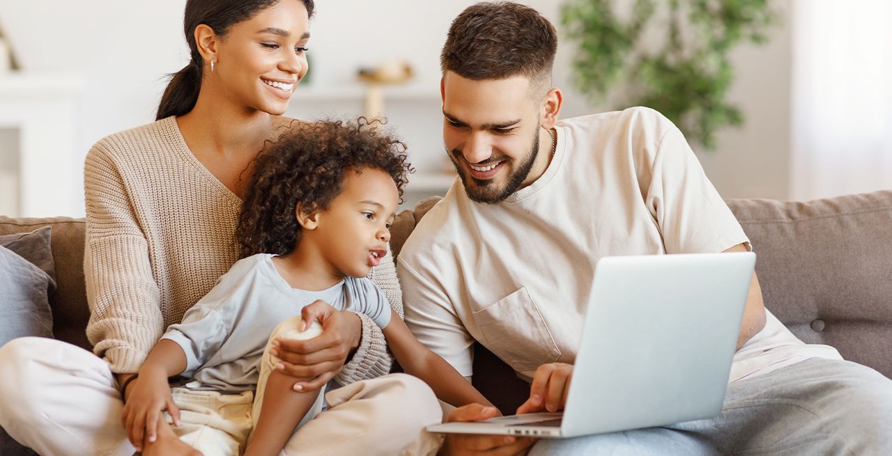 Family on the couch enjoying their fast Spectrum WiFi